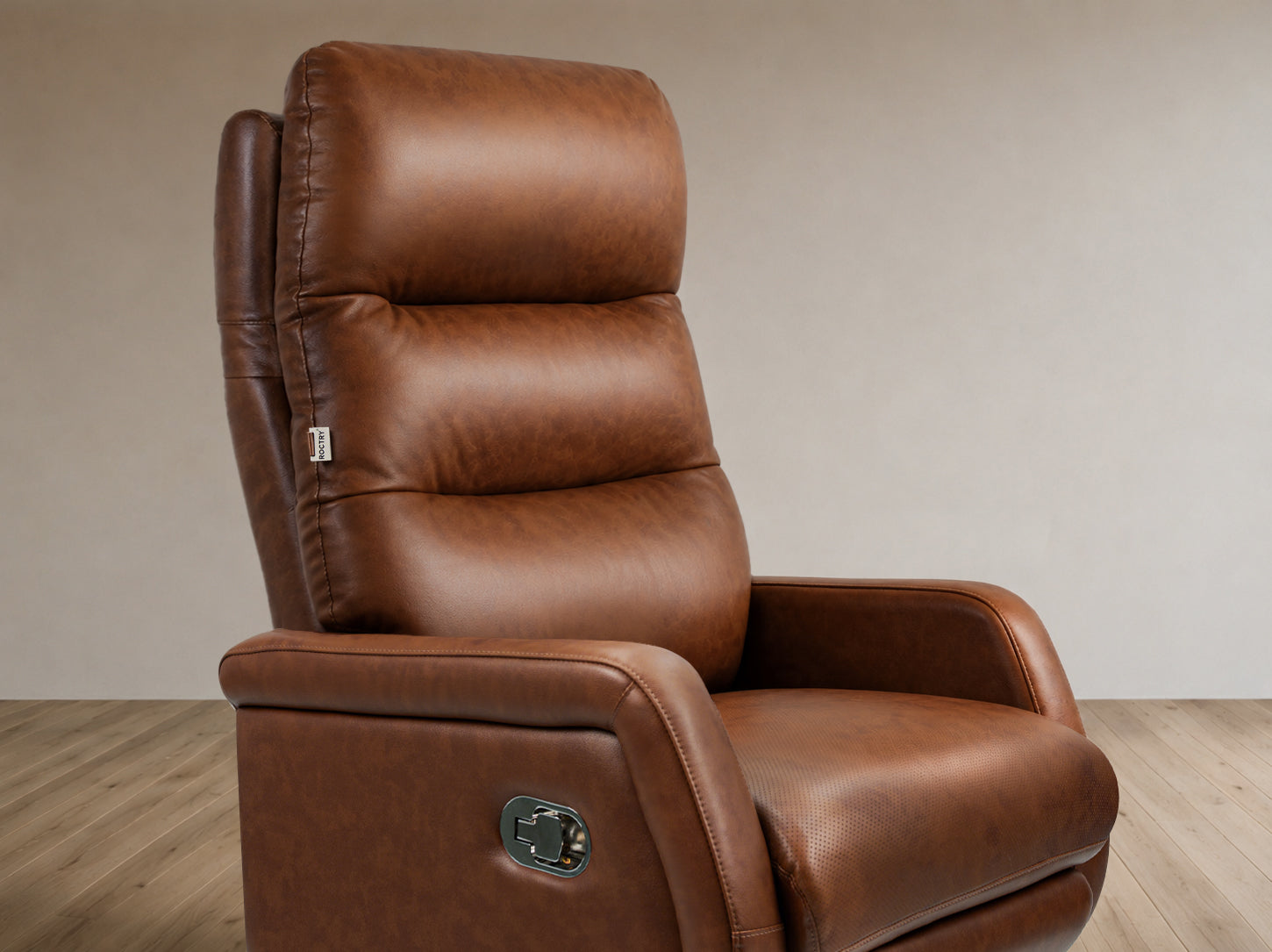 Brown leather recliner chair on a wooden floor with a beige wall background
