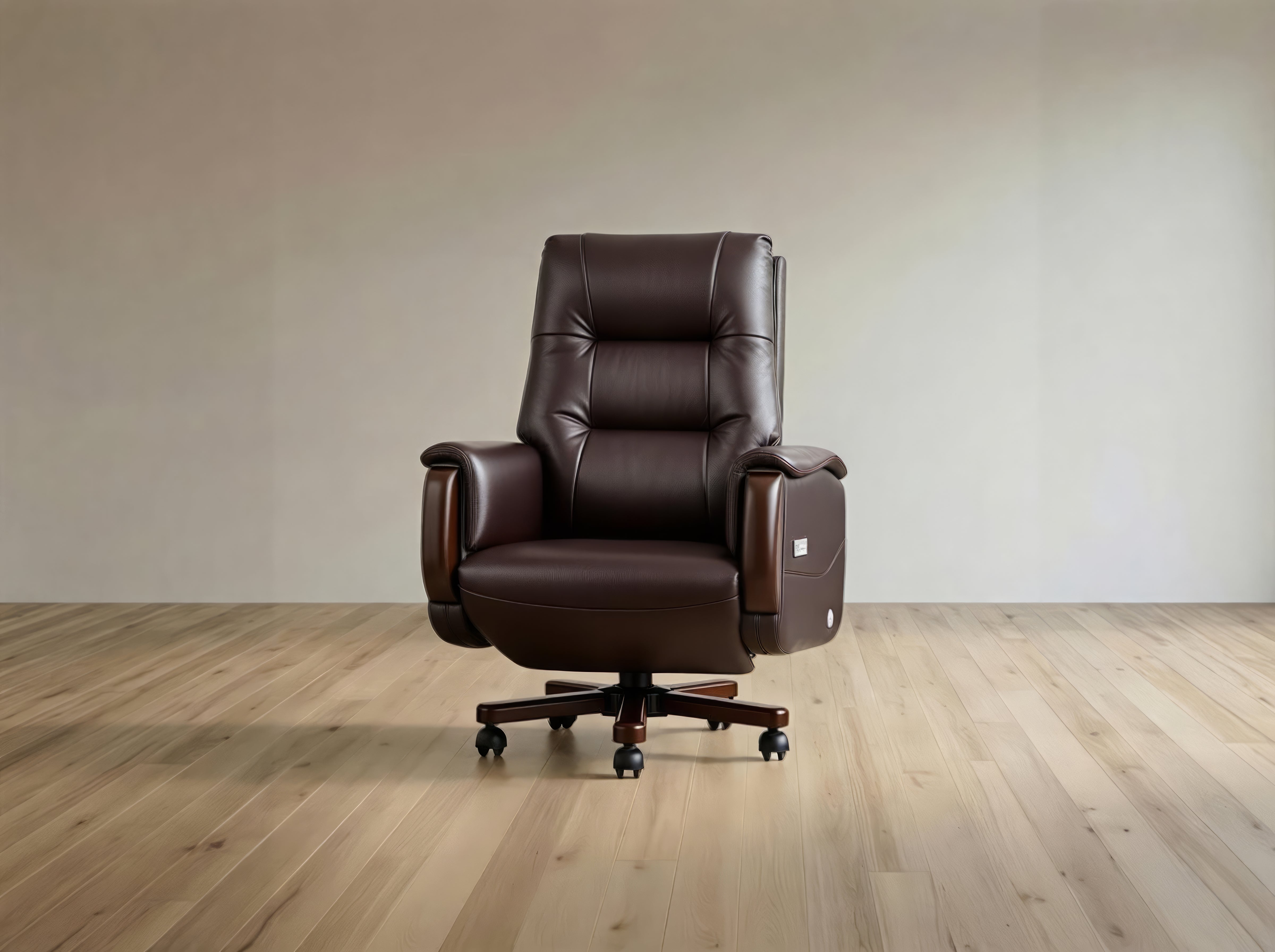 A dark brown leather office chair with a high back, padded armrests, and a five-star wheeled base, shown in a minimalist room with light wood flooring and a beige wall.
