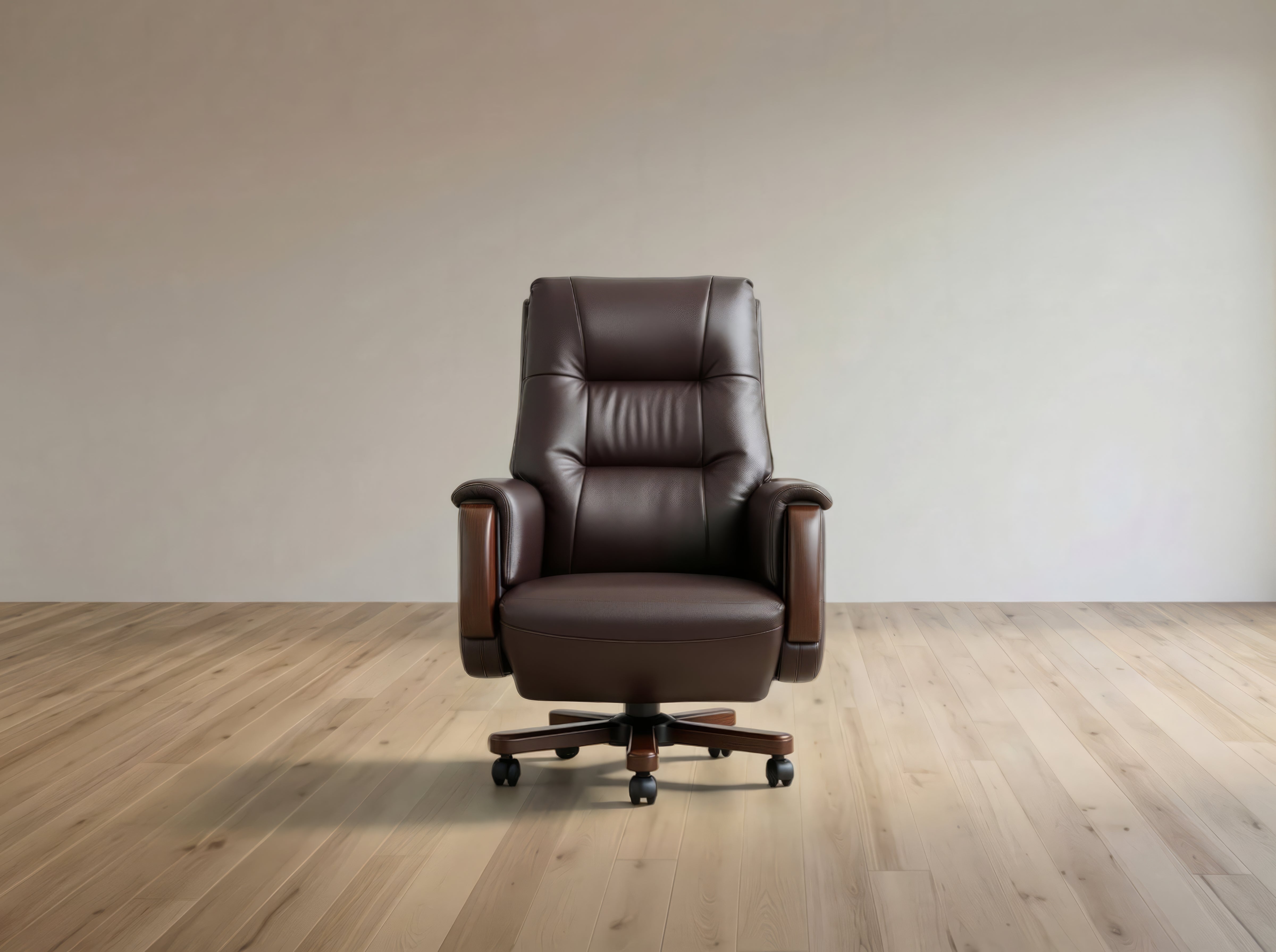 A dark brown leather office chair with a high back, padded armrests, and a five-star wheeled base, positioned in front of a plain beige wall on a light wood floor.