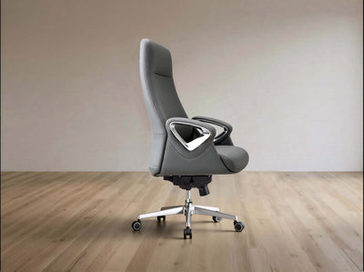 A modern gray office chair with a high back, textured fabric upholstery, and a silver five-star wheeled base, set against a minimalist beige wall and light wood floor.