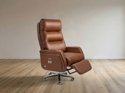 A brown leather recliner office chair with an extended footrest, mounted on a chrome five-star wheeled base, set against a minimalist beige wall and light wood floor.