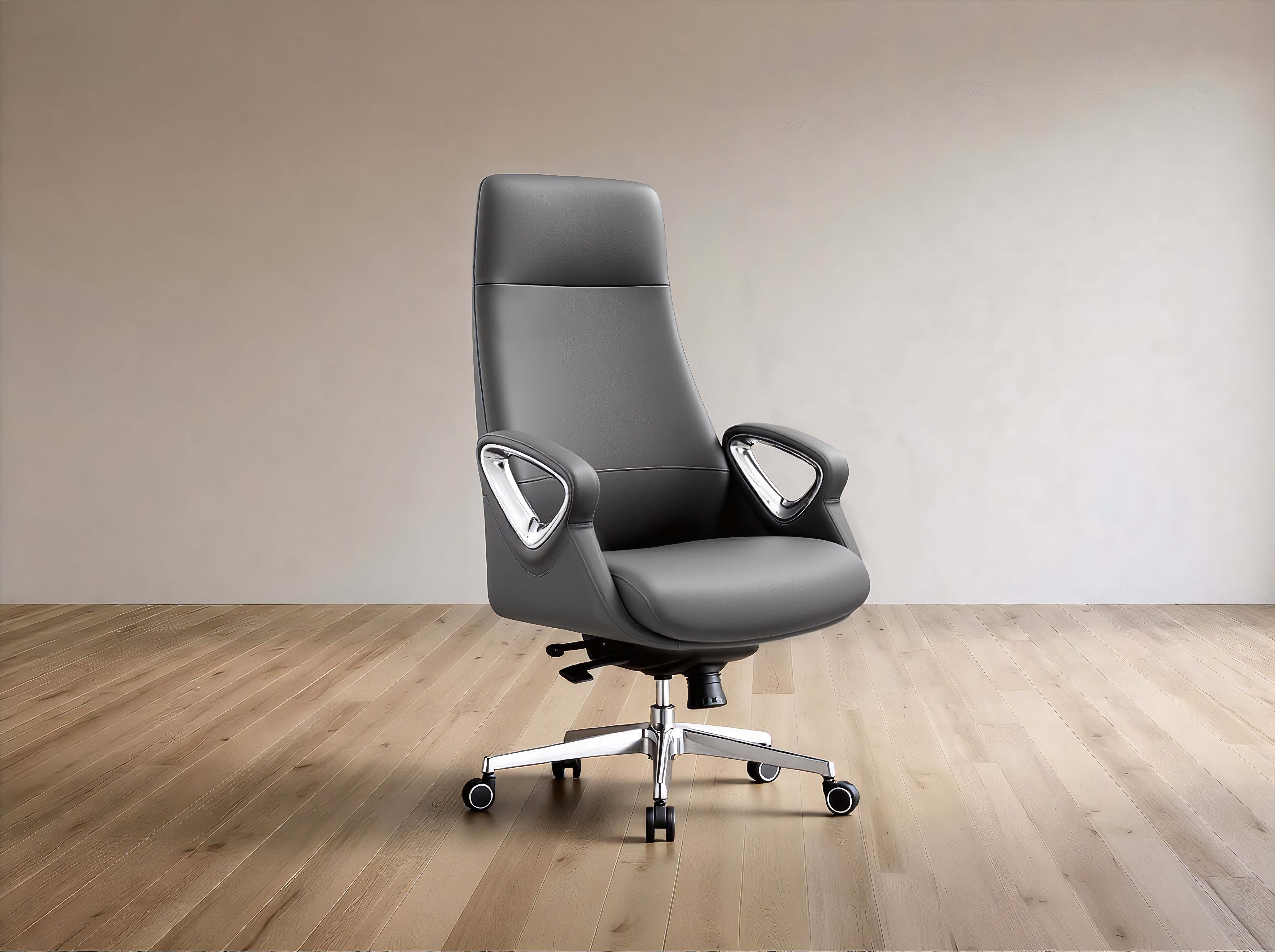 A modern gray leather office chair with a high back, curved armrests, and a chrome five-star base with casters, set against a minimalist beige wall and light wood floor.