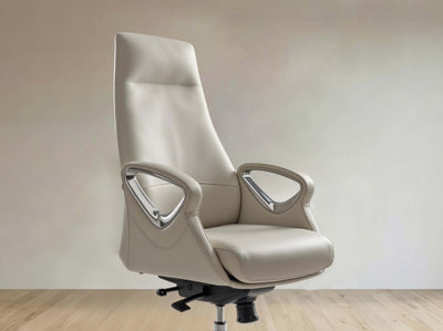 A high-back office chair upholstered in light beige leather with curved armrests and chrome accents, shown on a black wheeled base against a neutral beige wall and light wood floor.