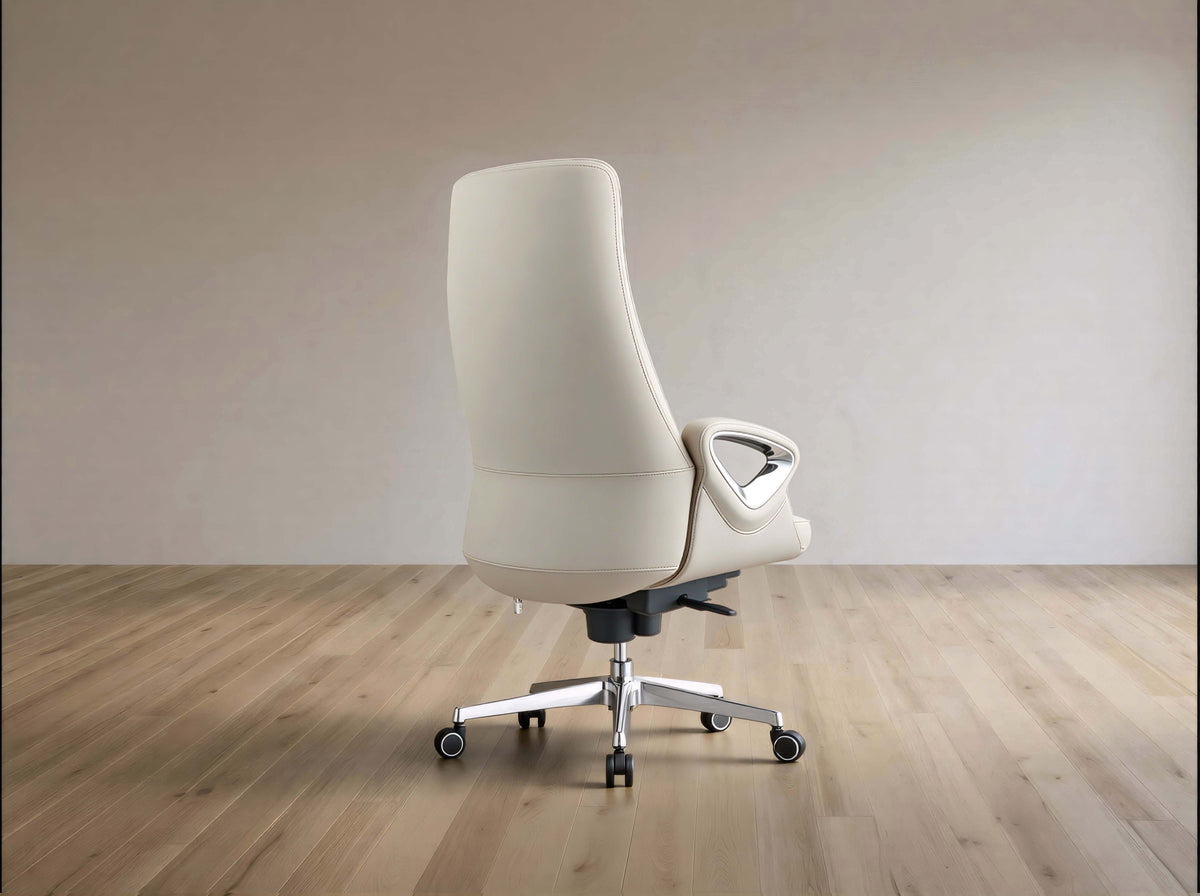 A modern off-white leather office chair with a high back, silver five-star base, and black casters, shown from the side against a minimalist beige wall and light wood floor.